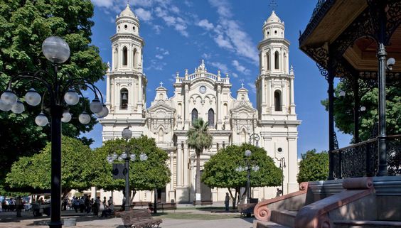 he stunning façade of a historic cathedral in Ciudad Obregón, showcasing its intricate architecture and the lush greenery of the surrounding plaza. This landmark is a testament to the city's rich cultural heritage and offers a peaceful retreat for visitors.