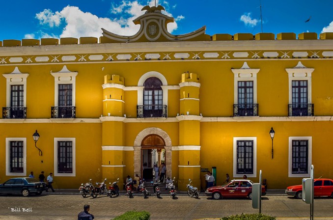 The vibrant yellow facade of the Campeche Municipal Building, a striking example of colonial architecture.