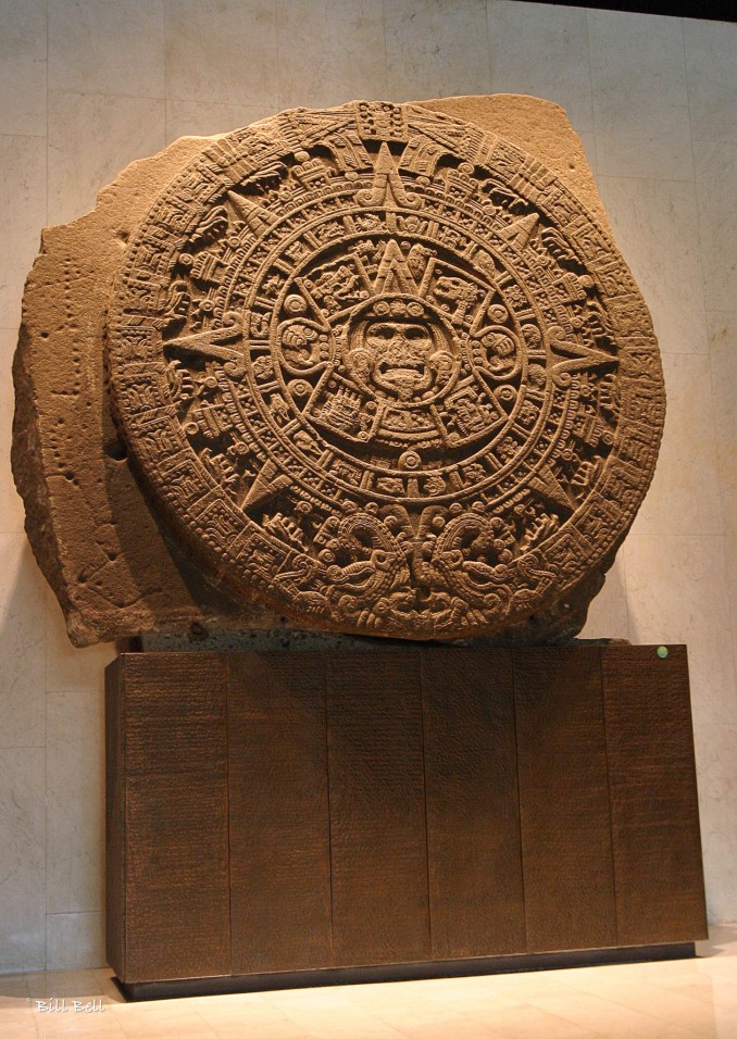 Aztec Sun Stone: The Aztec Calendar Stone, or Sun Stone, displayed in the National Museum of Anthropology in Mexico City. This monumental sculpture, often mistakenly thought to be a calendar, depicts the Aztec cosmology and their gods.