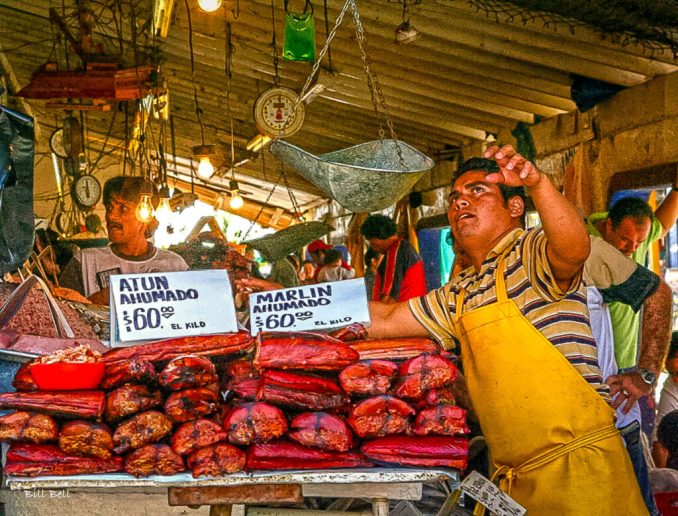 A bustling scene at the Ensenada Fish Market, where fresh seafood is a staple. The market is famous for its variety of fish and seafood, attracting both locals and tourists. The vendors' lively interactions and the fresh catch of the day make it a must-visit spot in Ensenada.