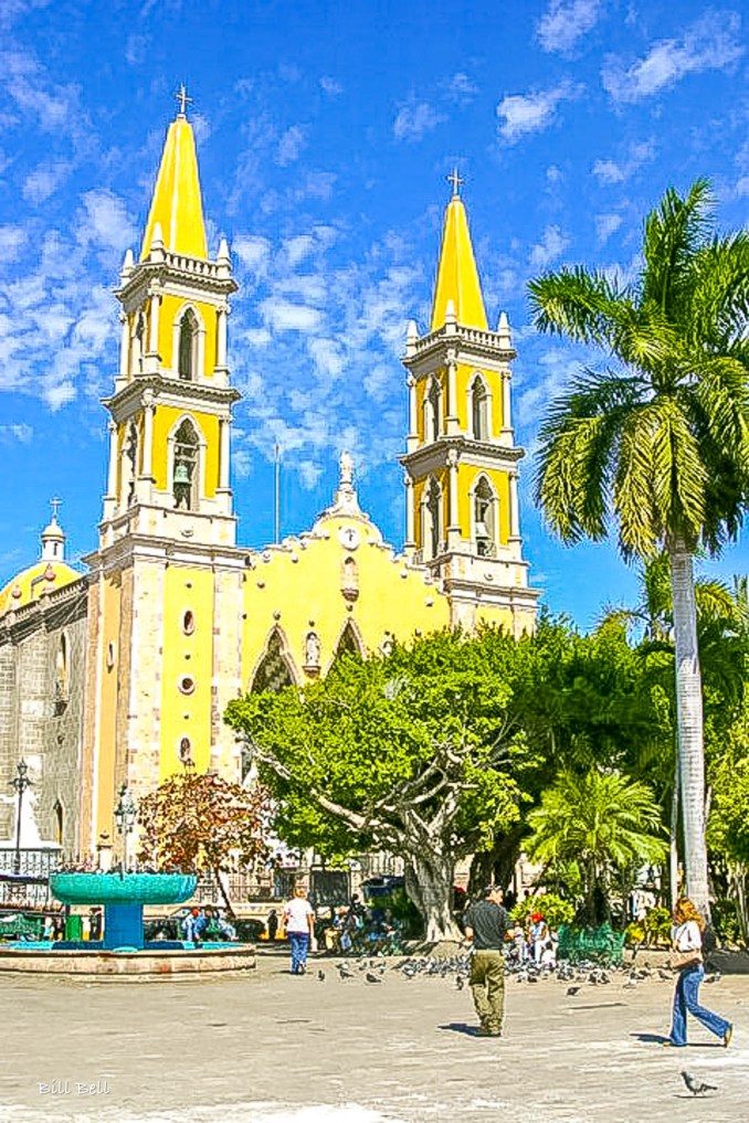 The impressive twin spiers of the Catedral Basílica de la Inmaculada Concepción rise above the central square in Mazatlán, a key landmark of the city's colonial heritage."