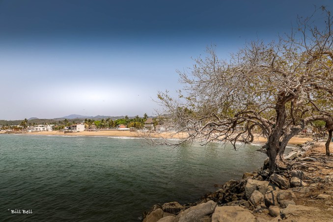  A serene view of the coastline at La Peñita de Jaltemba, where the tranquil waters meet the golden sandy beach, offering a peaceful retreat from the hustle and bustle.