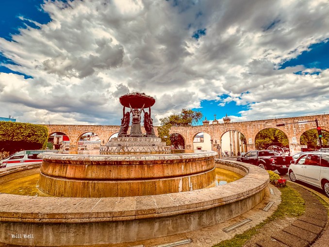 Close-up view of the Fuente de las Tarascas, a striking bronze fountain in Morelia that features three indigenous women holding a basket of fruits, symbolizing the region’s agricultural abundance.