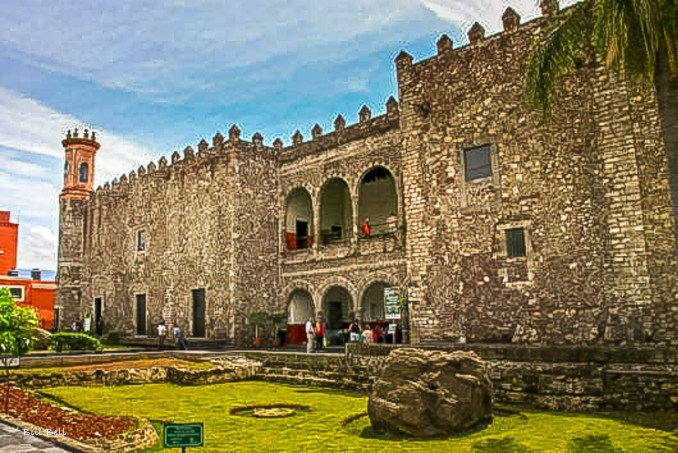 The formidable stone walls of the Palacio de Cortés in Cuernavaca, one of the oldest colonial-era buildings in Mexico, now serving as a museum dedicated to the region's rich history.