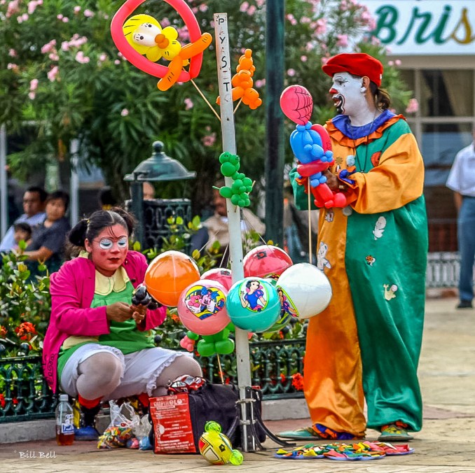 Clowns in the Square:Colorful clowns entertain children and families in the main square of Catemaco, adding to the town's vibrant and festive atmosphere. (Photo by Bill Bell)