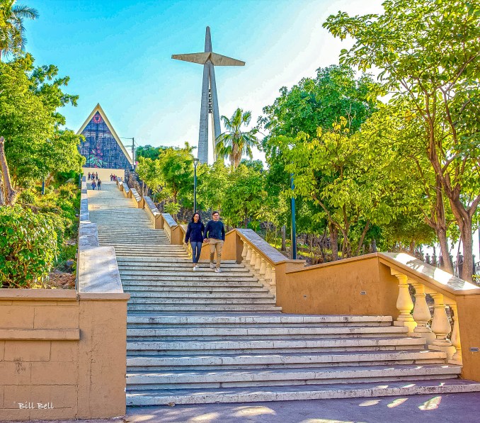 Steps to the ShrineVisitors walk up the steps leading to the Jesús Malverde Shrine, illustrating the devotion and pilgrimage to this unique cultural site.