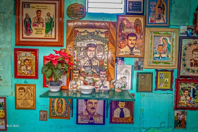 The Altar of Jesús MalverdeThe altar at the Jesús Malverde Shrine is filled with flowers, candles, and statues, creating a focal point for prayer and reflection. Devotees leave offerings and notes of thanks, seeking the blessings and protection of Malverde.