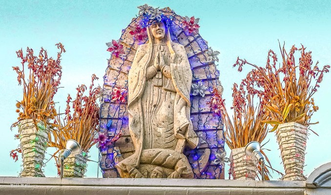 Our Lady of Guadalupe StatueThe stunning statue of Our Lady of Guadalupe at the Jesús Malverde Shrine in Culiacán, adorned with flowers and colorful lights, serves as a beacon of hope and faith for the local community.