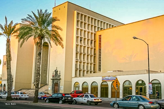 The modern architecture of Hermosillo's city center basks in the golden light of sunset, showcasing the city's blend of tradition and modernity.