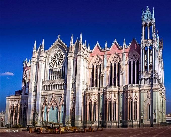 The stunning Gothic architecture of the León Cathedral, bathed in the golden light of the afternoon sun, highlighting its intricate designs and towering spires.