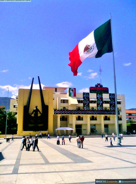 The imposing Mexican flag flies high over the Government Palace in Chilpancingo. This central plaza, with its unique architecture and design, is a bustling hub for locals and tourists alike, reflecting the pride and cultural identity of Guerrero's capital city.