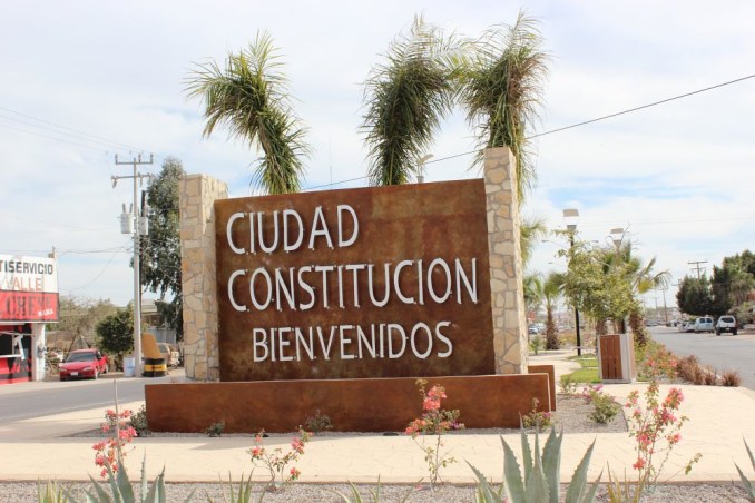  "The warm and inviting welcome sign of Ciudad Constitución greets travelers, hinting at the vibrant agricultural hub and rich cultural experiences that lie ahead."