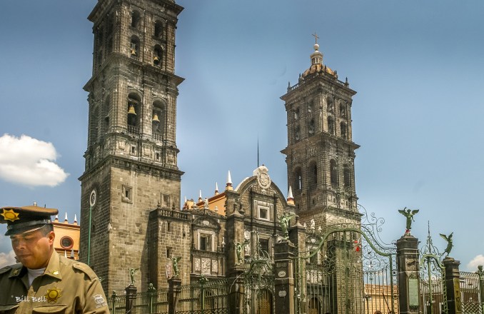 "A policeman stands near Puebla’s iconic cathedral, a towering symbol of the city’s colonial past and spiritual heart, which draws visitors from around the world