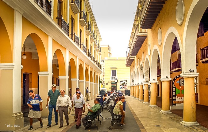 A quiet passageway in downtown Veracruz, where locals gather to chat and relax under the arcades, offers a glimpse into everyday life in the historic city. The colonial architecture adds to the ambiance, blending history with contemporary life. © Bill Bell