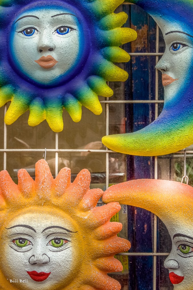 Colorful ceramic sun and moon wall hangings on display in Tonalá, Jalisco, where artisans craft a variety of vibrant home decor pieces. This charming town east of Guadalajara is renowned as Mexico's “Shopping Mecca,” especially famous for its pottery, glasswork, and unique market days.