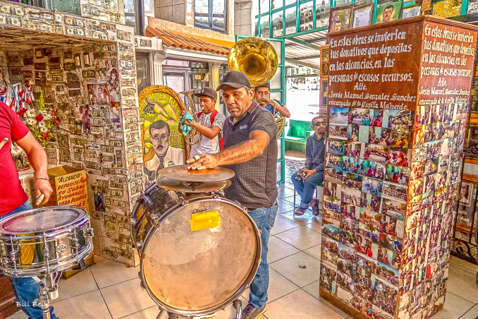 Live Music at the Jesús Malverde ShrineA band plays lively music inside the Jesús Malverde Shrine, adding to the vibrant and eclectic atmosphere. The shrine is not only a place of prayer but also a gathering spot for community celebrations and traditions.